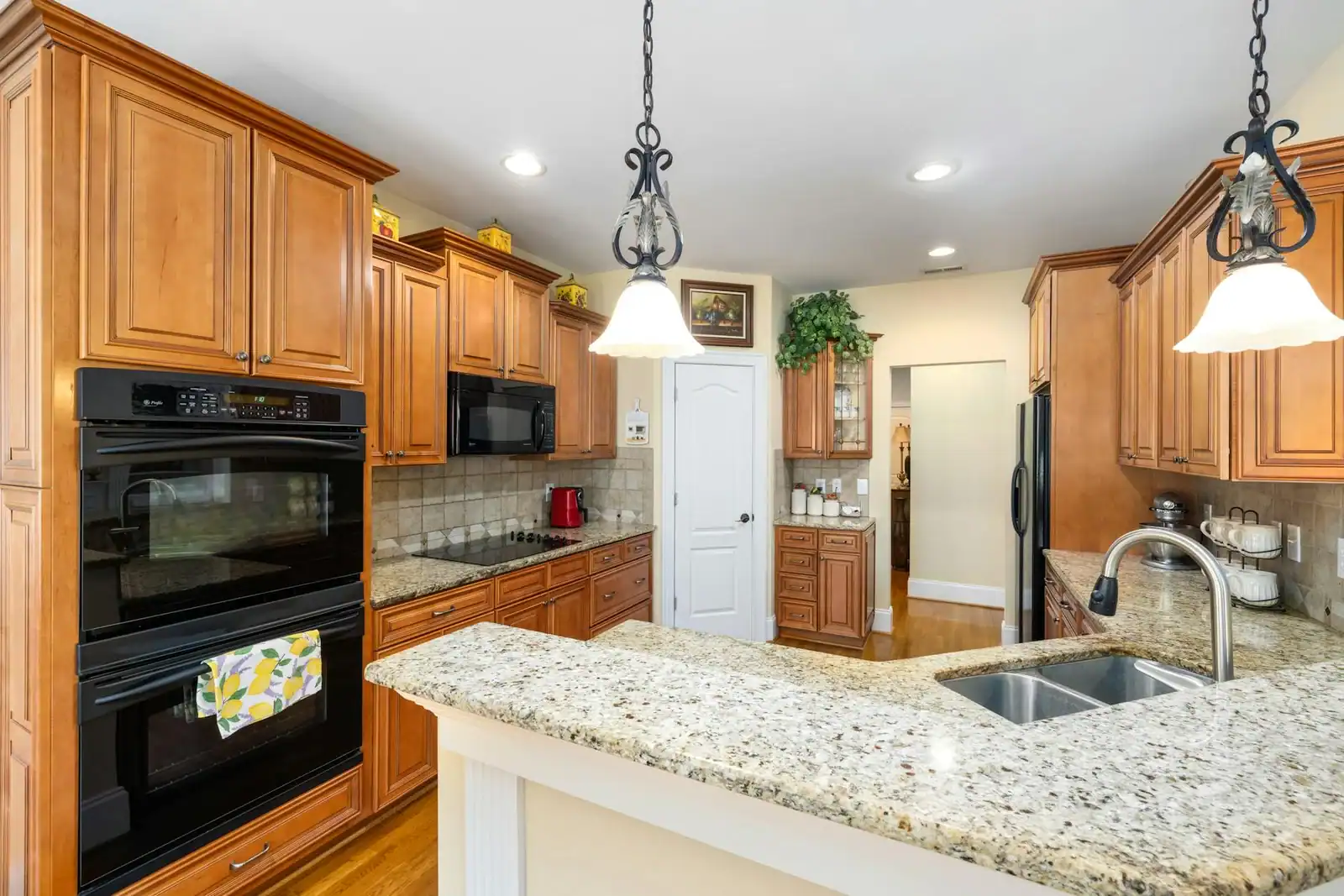 Spacious kitchen featuring wooden cabinets, granite countertops, and modern appliances.