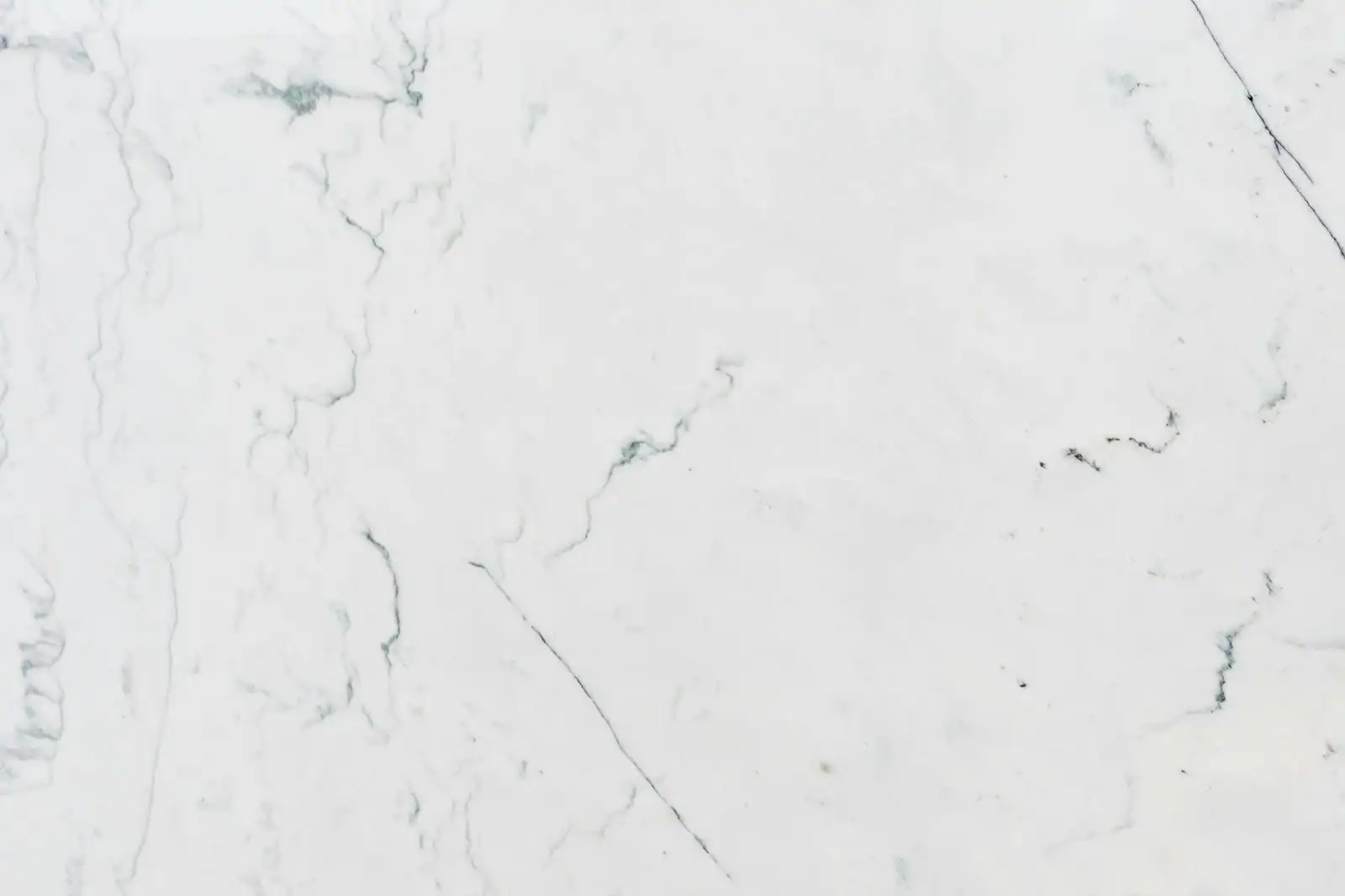 Elegant close-up of white marble with natural veining, perfect for backgrounds.