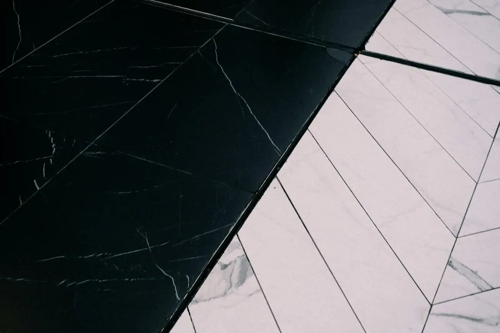 Stylish black and white marble tiles with a geometric pattern creating a striking contrast.
