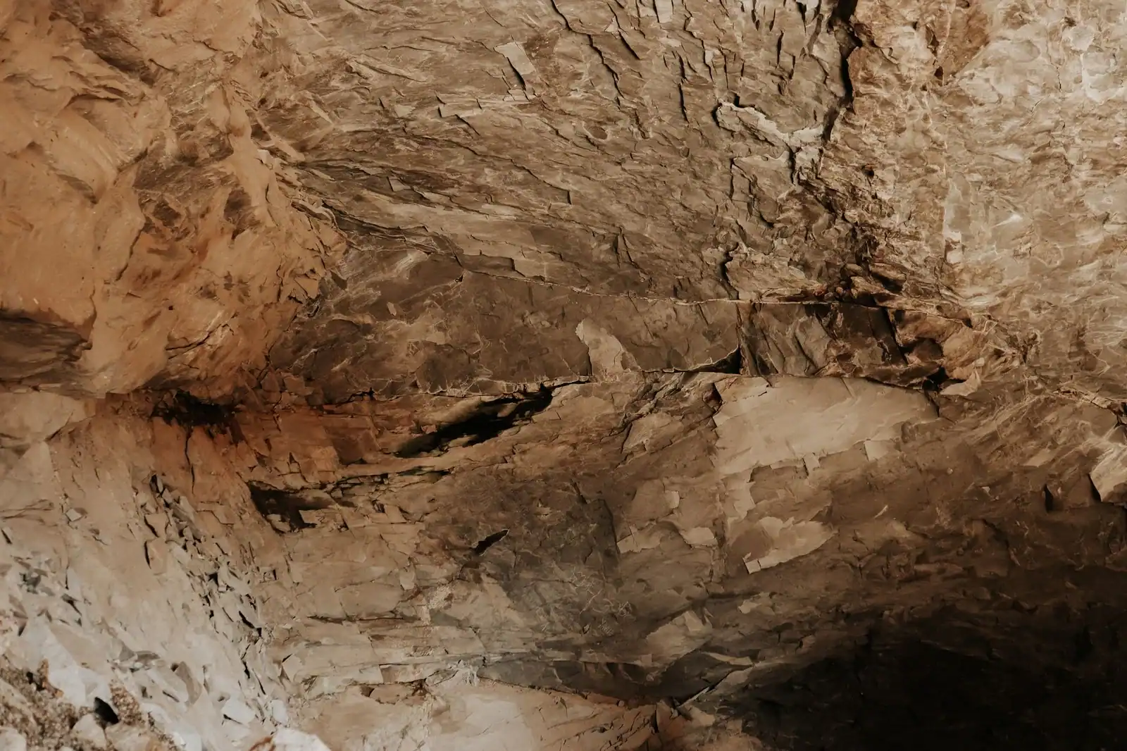 Detailed view of a rugged rock formation inside a cave showcasing natural texture and patterns.