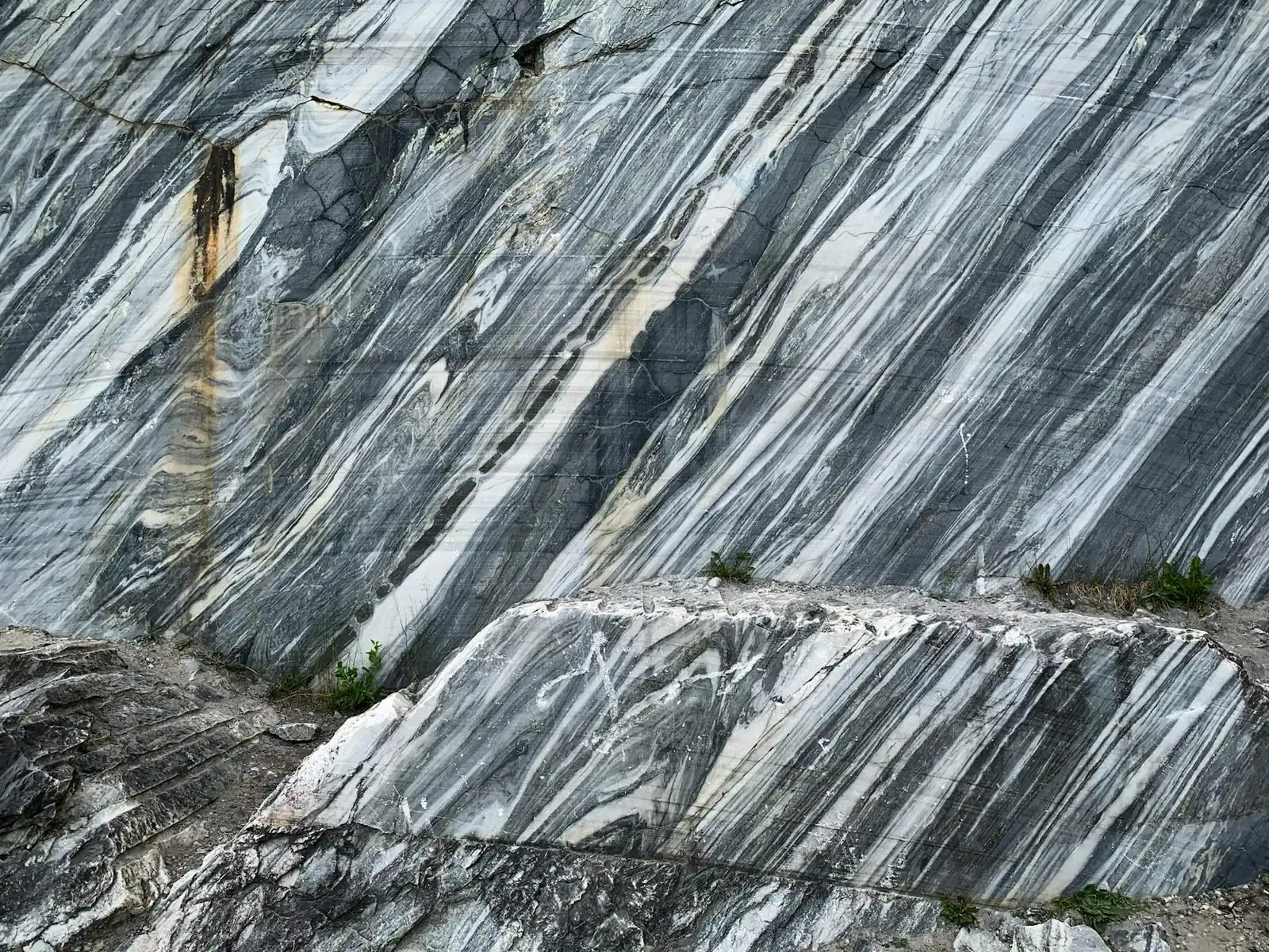 Close-up of a textured marble rock surface with natural gray patterns and weathered textures.