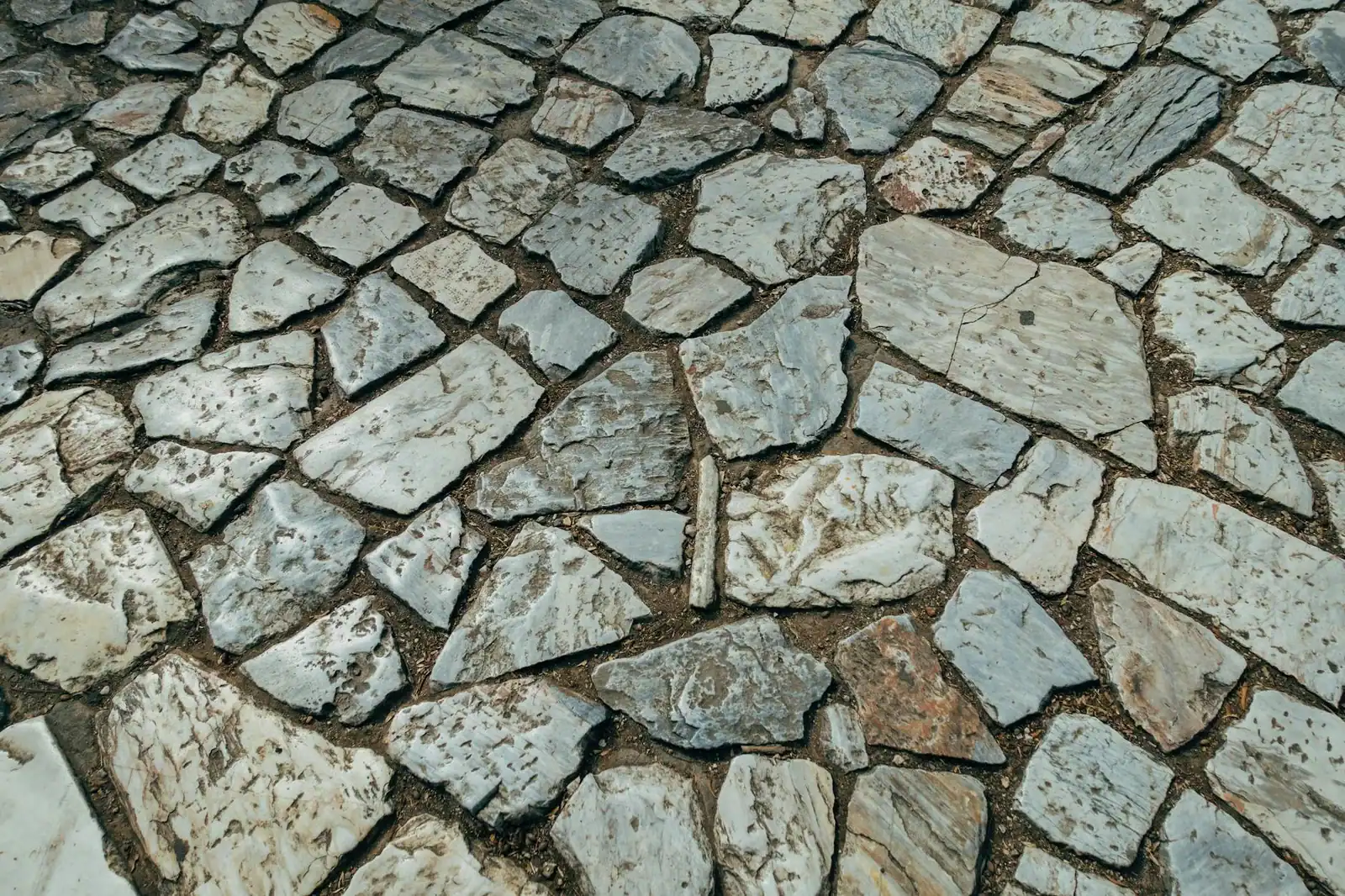 Close-up view of a rugged stone pavement showcasing natural patterns and textures.