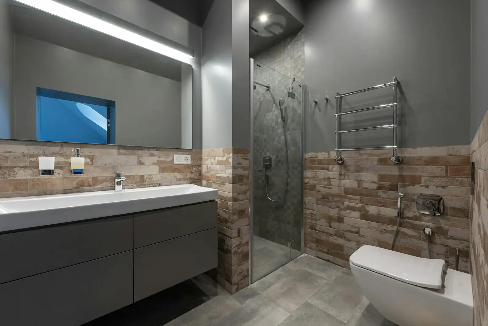 Sleek modern bathroom featuring a glass shower, floating vanity, and stylish decor.