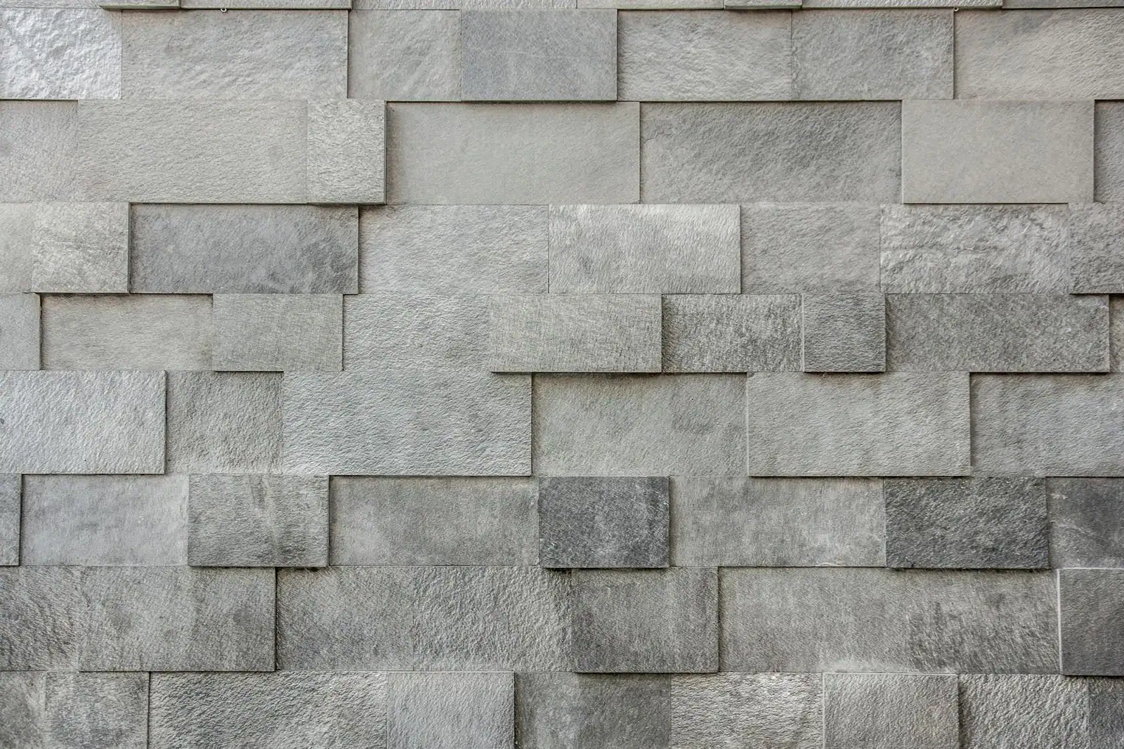 Close-up of a gray textured brick wall with seamless pattern.