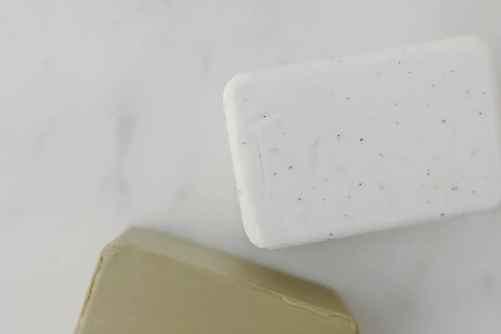 Elegant overhead shot of two soap bars on marble, perfect for skincare and hygiene themes.